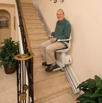 man-riding-stair-lift-by-hoveround-lg.webp